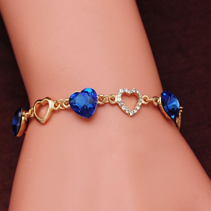 Dainty gold-tone double heart bracelet with crystal accents.
