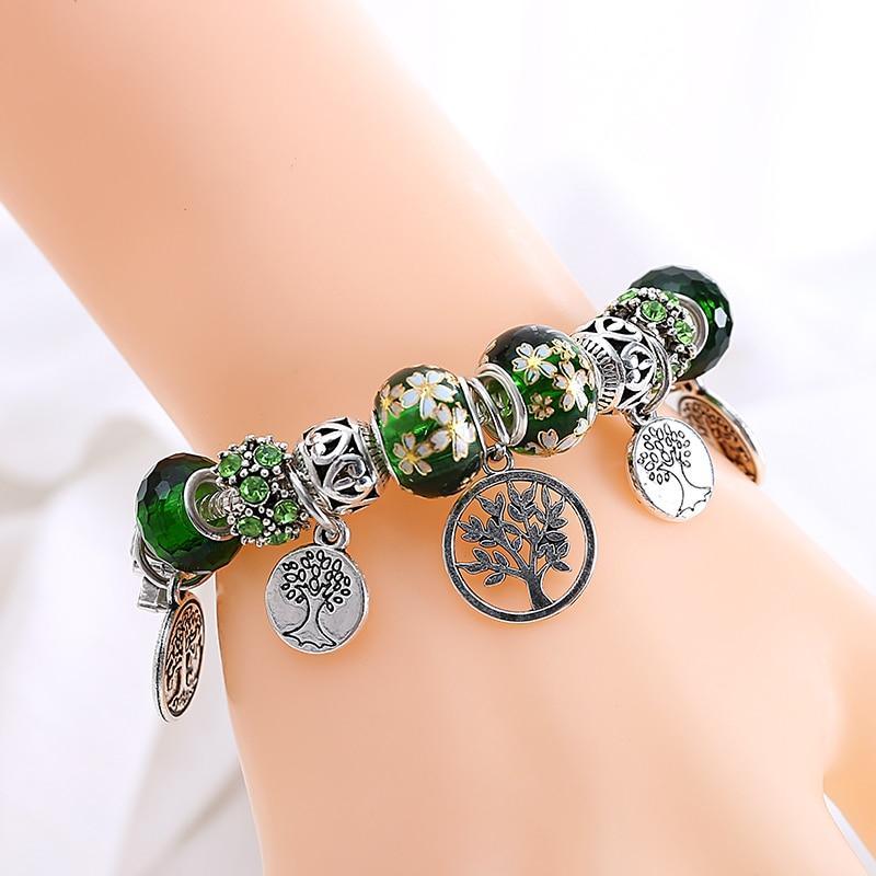Silver tone Tree of Life charm bracelet with green leaf crystal accents