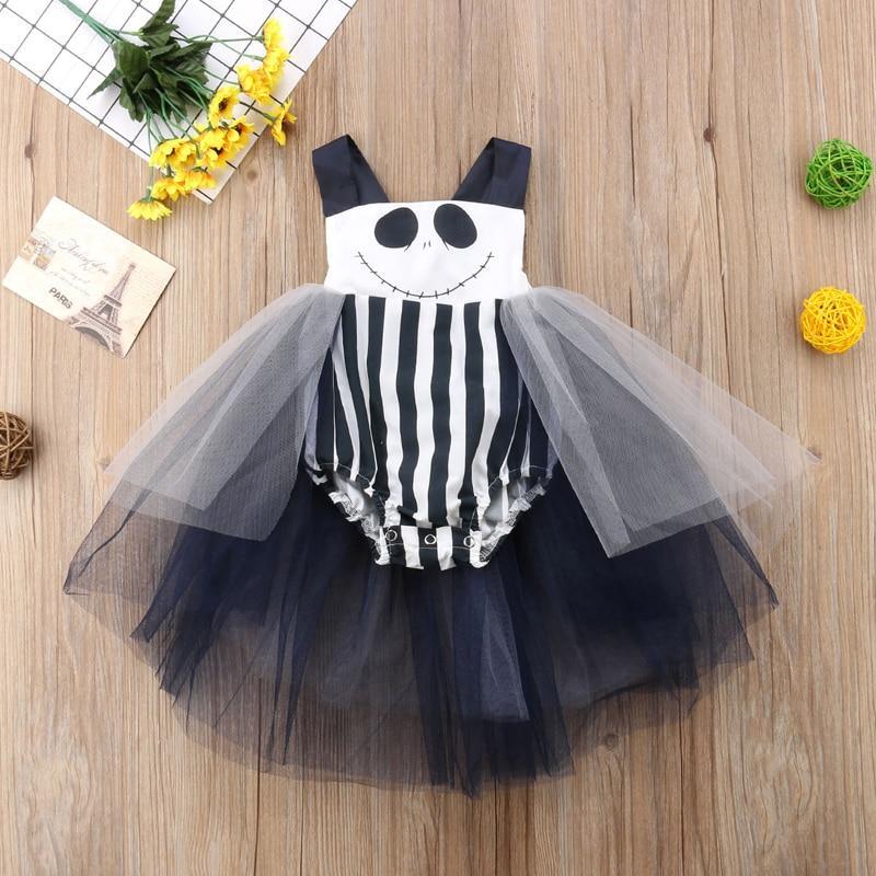 Baby girl wearing a black and white striped Halloween tulle romper dress