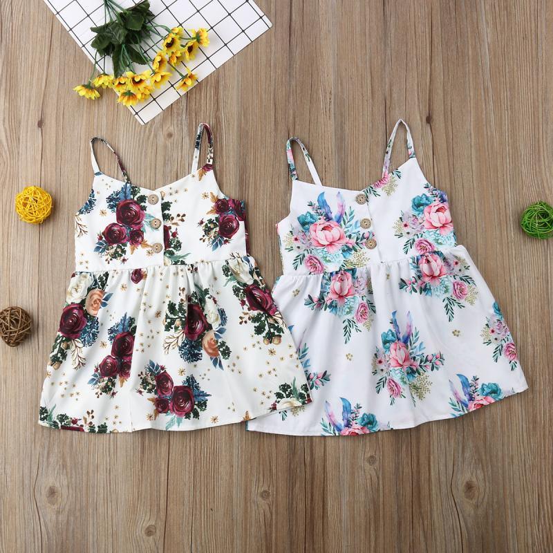 Toddler girl wearing a sleeveless floral V-neck dress in a bohemian style
