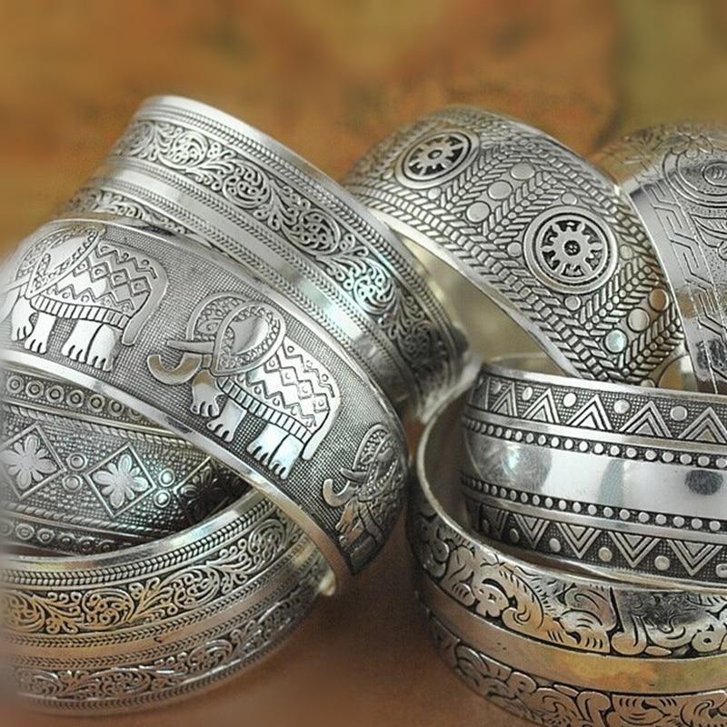 Vintage Tibetan silver cuff bangle with intricate flower and animal engravings