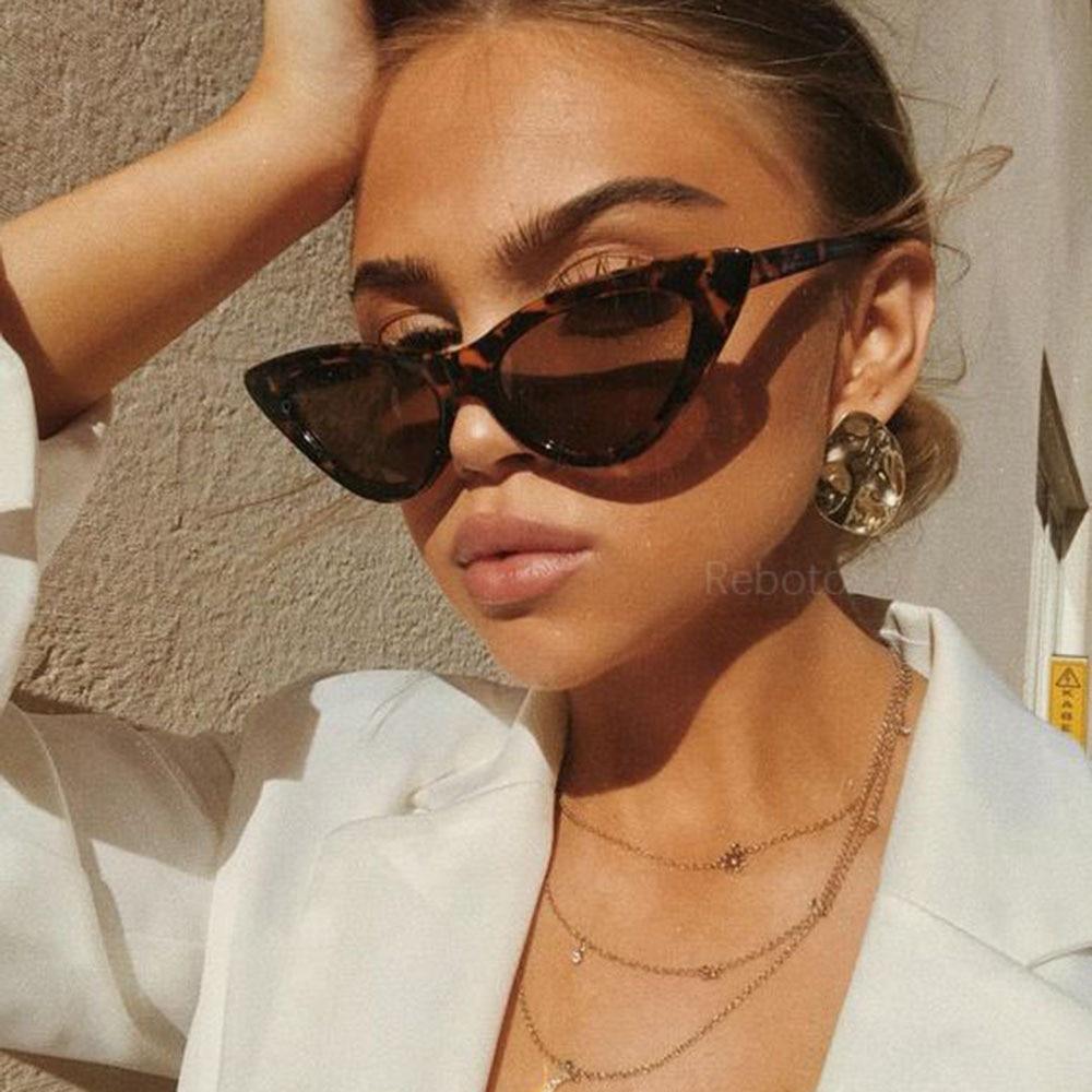 Retro cat eye sunglasses with white triangle detail on black frame