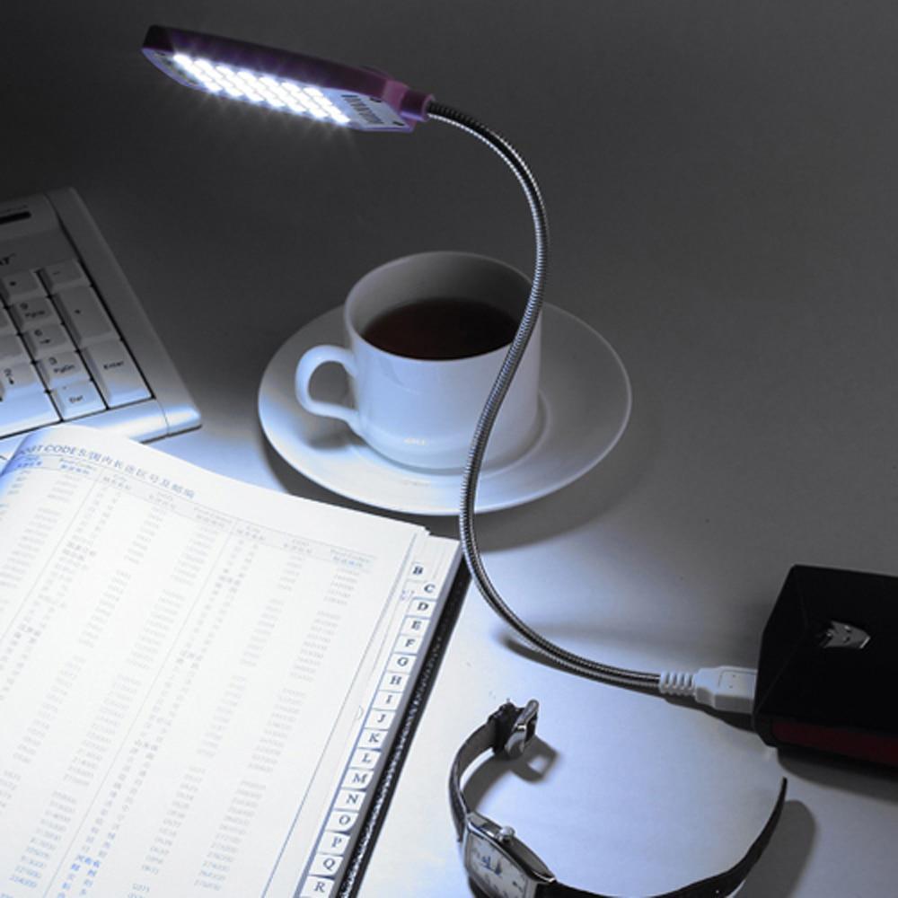 Flexible pink LED USB lamp clipped onto a laptop keyboard