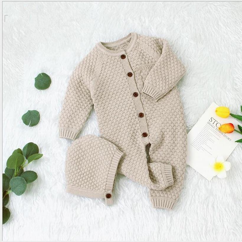 Baby wearing a classic knitted cotton romper with a matching winter hat