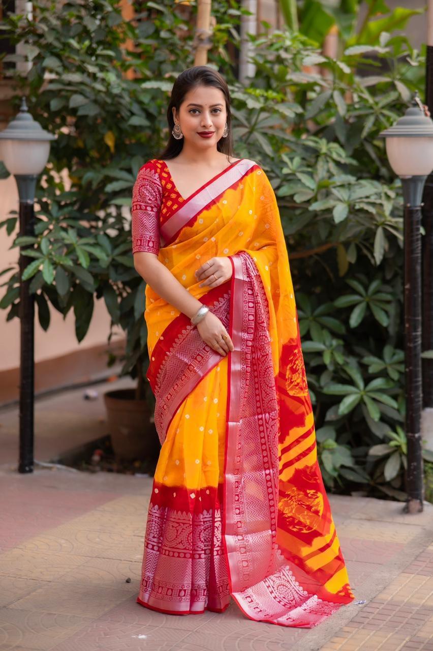 Orange jute silk saree with Bandhani print and decorative cut-broaso border