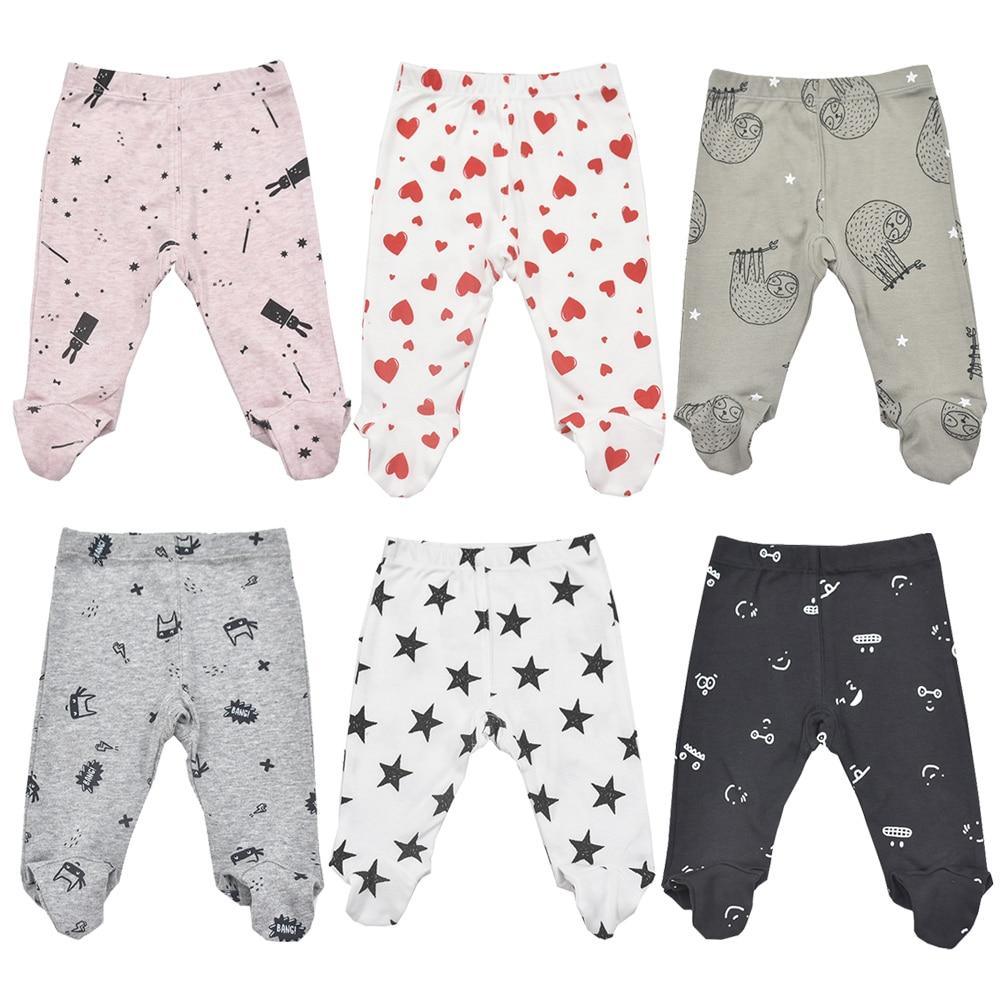 Soft cotton footed baby trousers in assorted minimalist colors