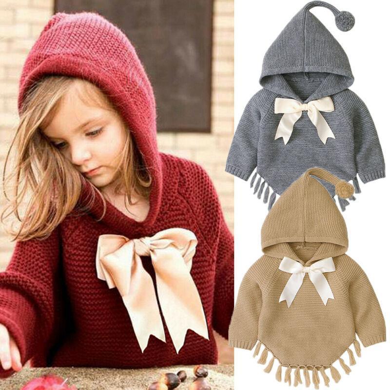 Toddler girl wearing a soft, bowknot-detailed knit cloak in red