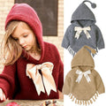 Toddler girl wearing a soft, bowknot-detailed knit cloak in red