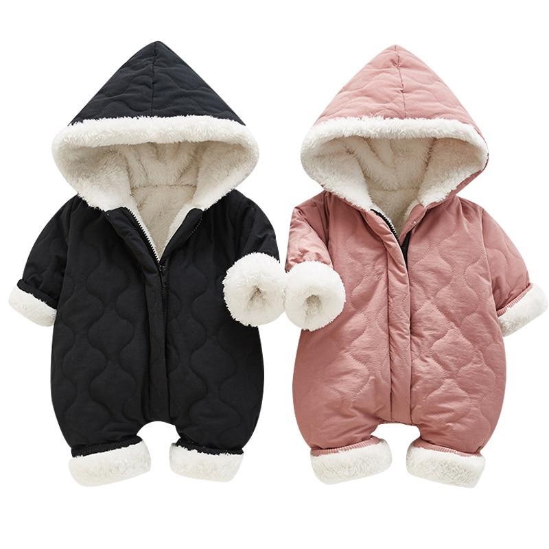 Baby in a black plush thickened jumpsuit with sherpa trim hood and contrasting zipper