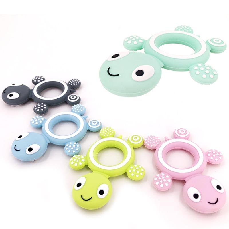 Cute turtle-shaped silicone baby teether in a vibrant mint color for teething relief