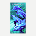 Florida beach towel featuring a graphic of four dolphins in blue and teal water
