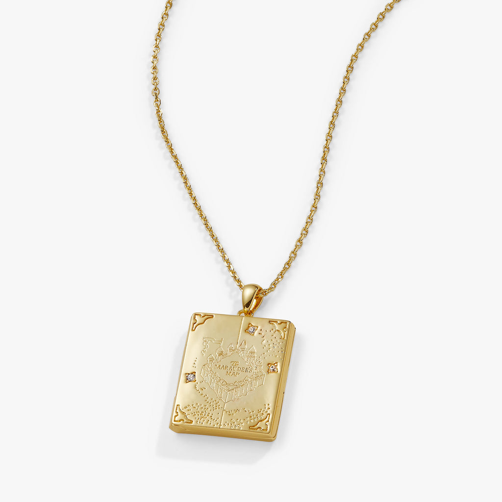 Harry Potter Mischief Managed gold locket necklace on a display background