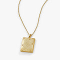 Harry Potter Mischief Managed gold locket necklace on a display background