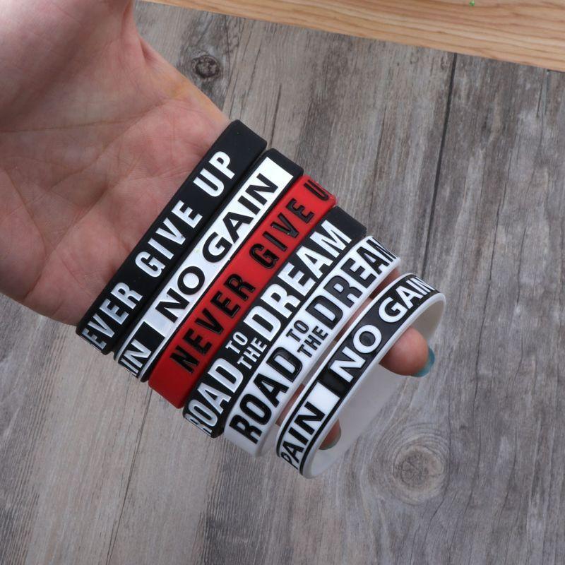 Set of motivational silicone bracelets in black, white, and red colors