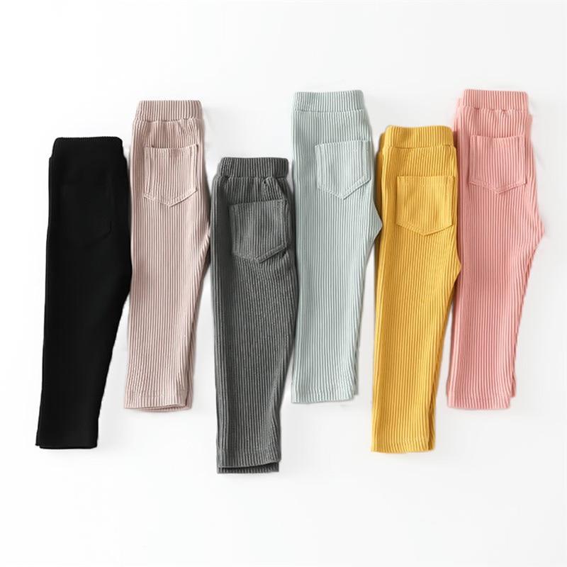 Girl wearing candy-colored patchwork cotton leggings with a flat elastic waist