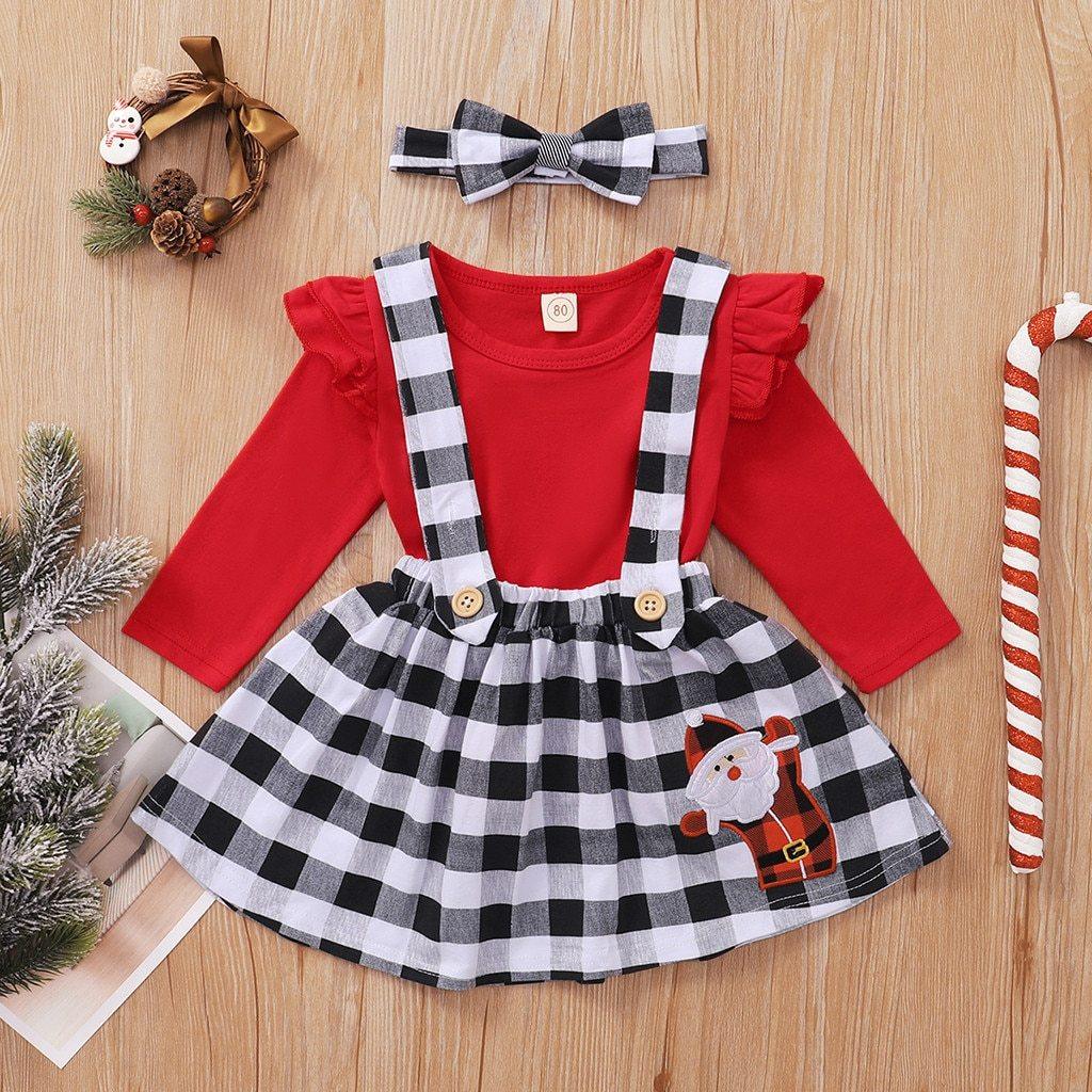 Toddler girl wearing a cute red, white, and black plaid suspender dress for winter