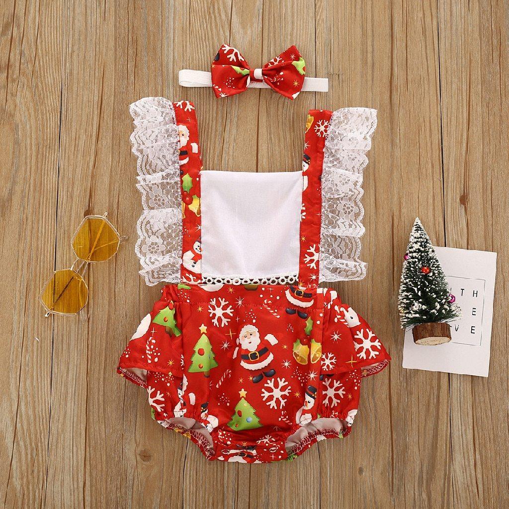 Baby girl festive Christmas romper with suspender dress and red and white holiday pattern.