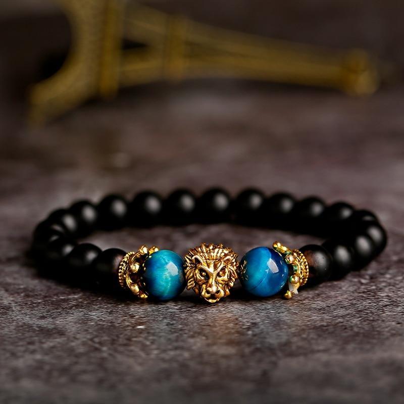 Handmade beaded bracelet with natural Tiger Eye and Onyx stones and a decorative gold lion charm.