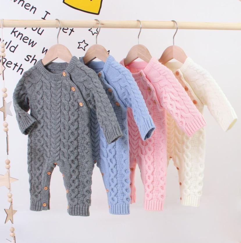 Classic handmade knitted long sleeve baby romper in neutral tones