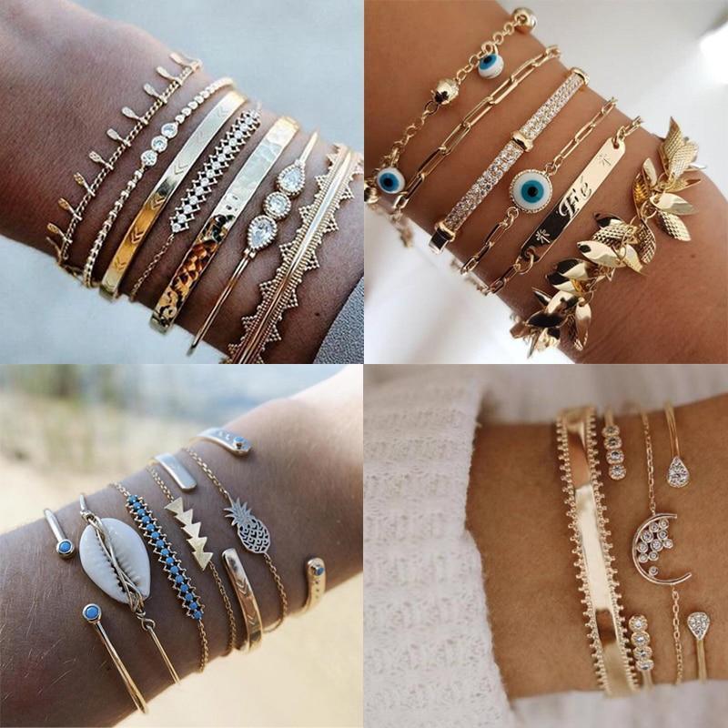 Bohemian gold-tone chain bracelet with hanging tassels, shells, and crystals