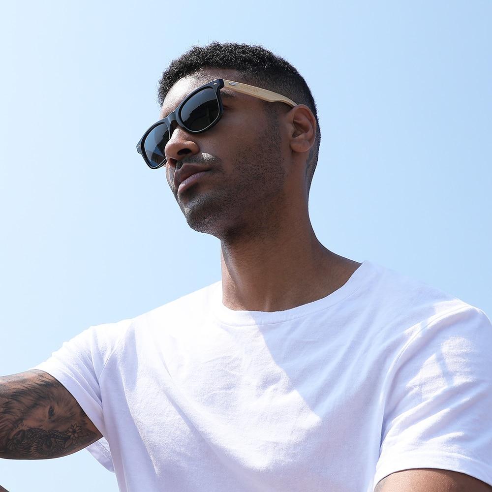Unisex polarized sunglasses with natural bamboo frames and black lenses against a neutral background.