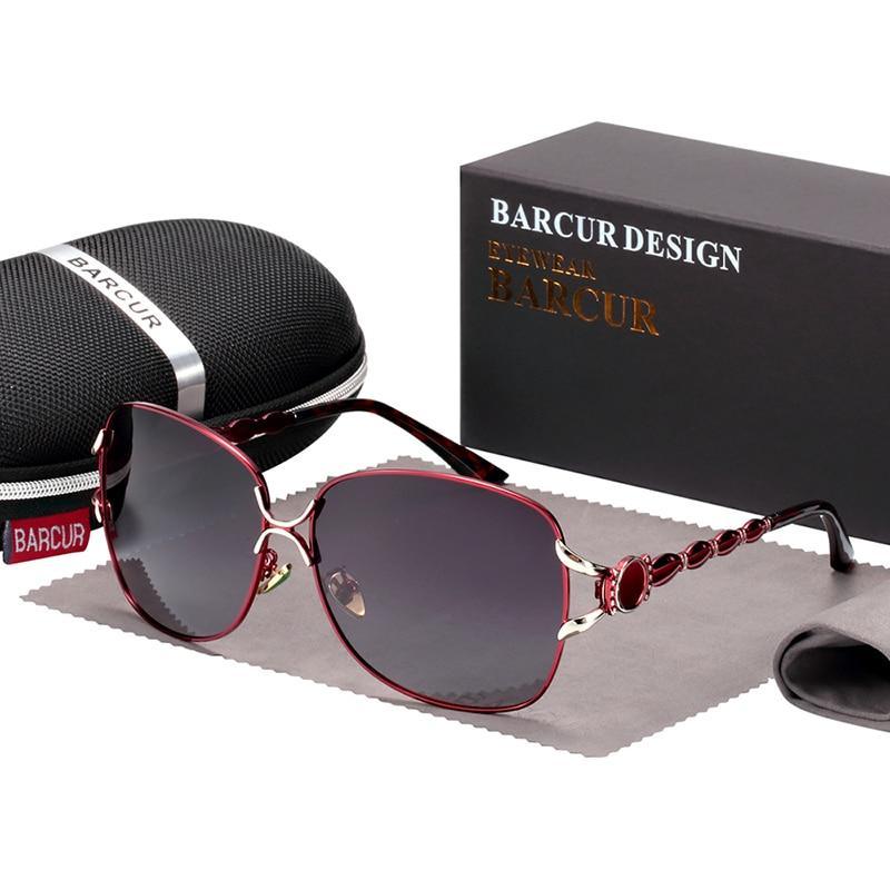 Glamorous oversized women's sunglasses with gold accents and pearl detailing.