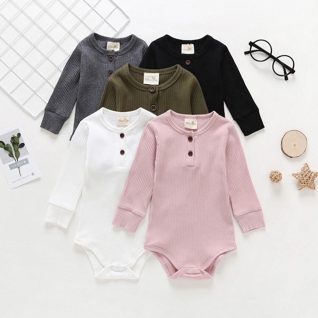 Neutral tone ribbed cotton baby romper in a minimalist style