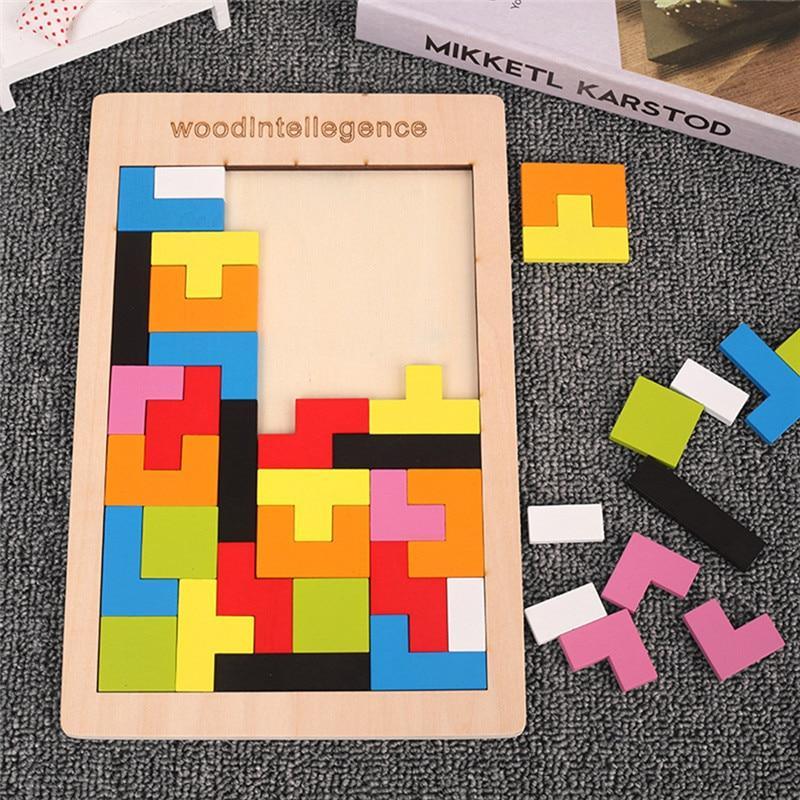 Colorful wooden 3D Tetris puzzle sculpture arranged on a clean, modern tabletop surface.