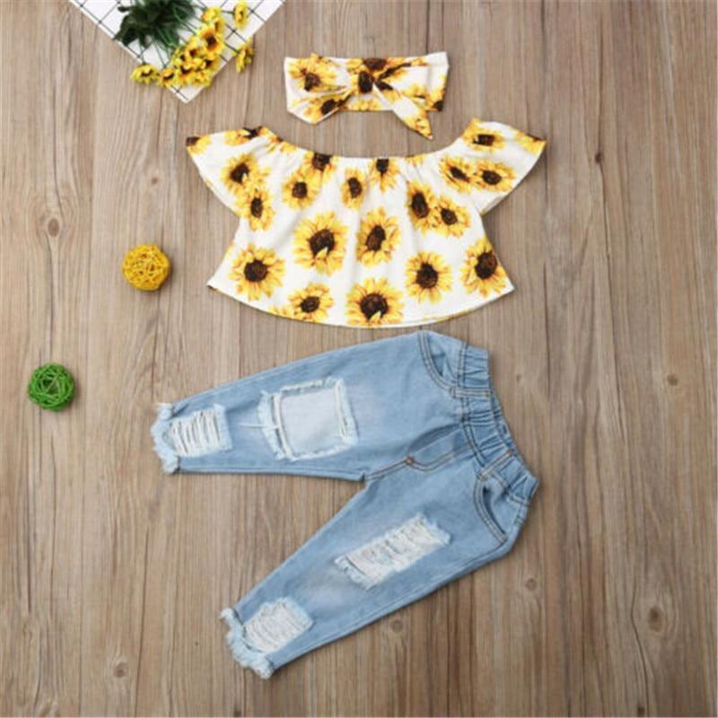 Baby girl 3-piece outfit with sunflower floral top, light-blue pants, and matching headband
