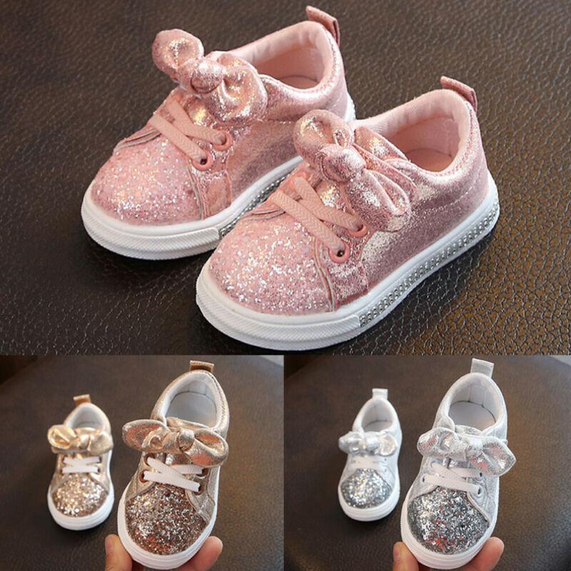Playful toddler sneakers with sequin bow detail in pink, available in gold and silver