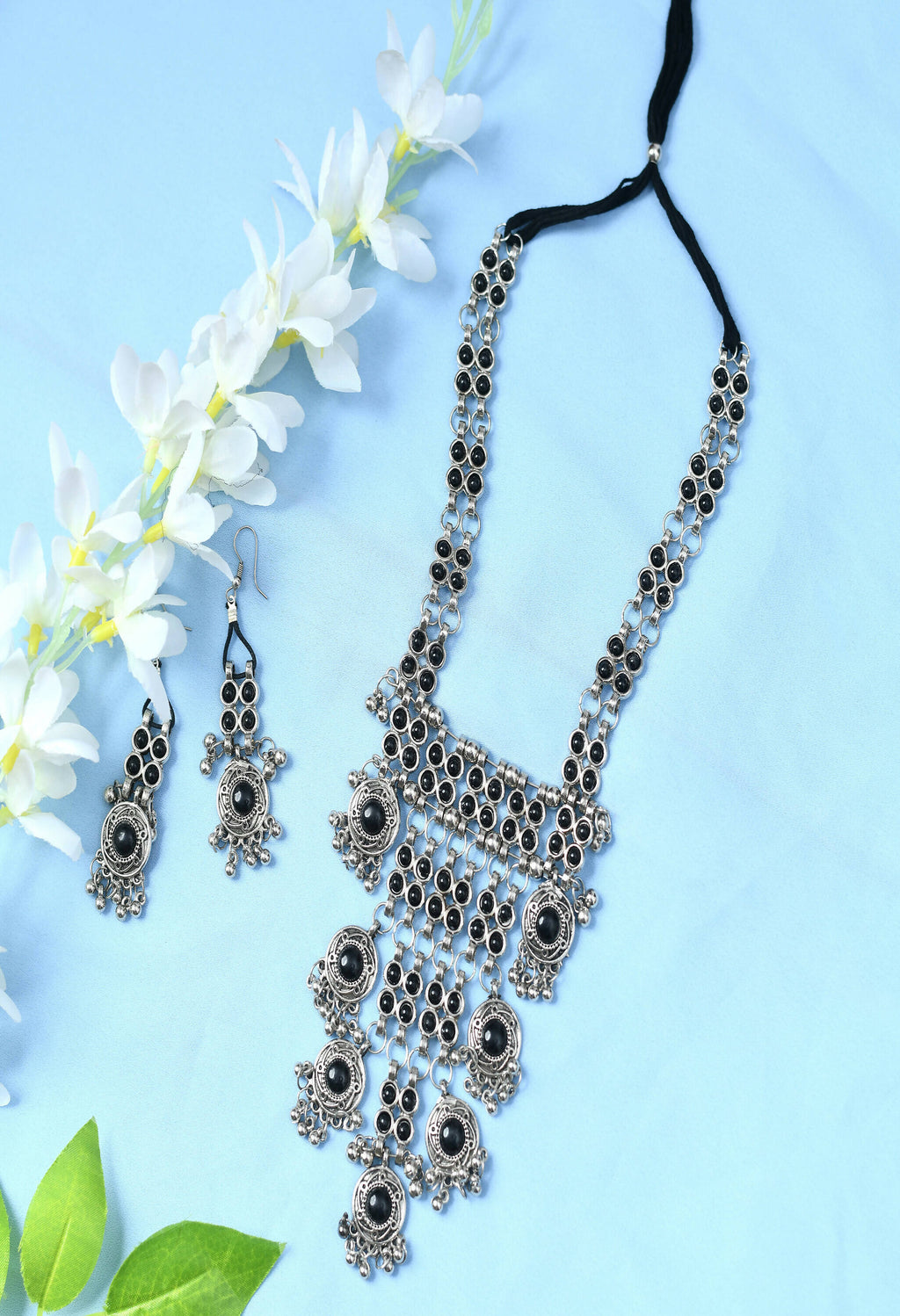 A long Afghani-style necklace featuring black Kundan stones set in oxidised silver-plated brass.