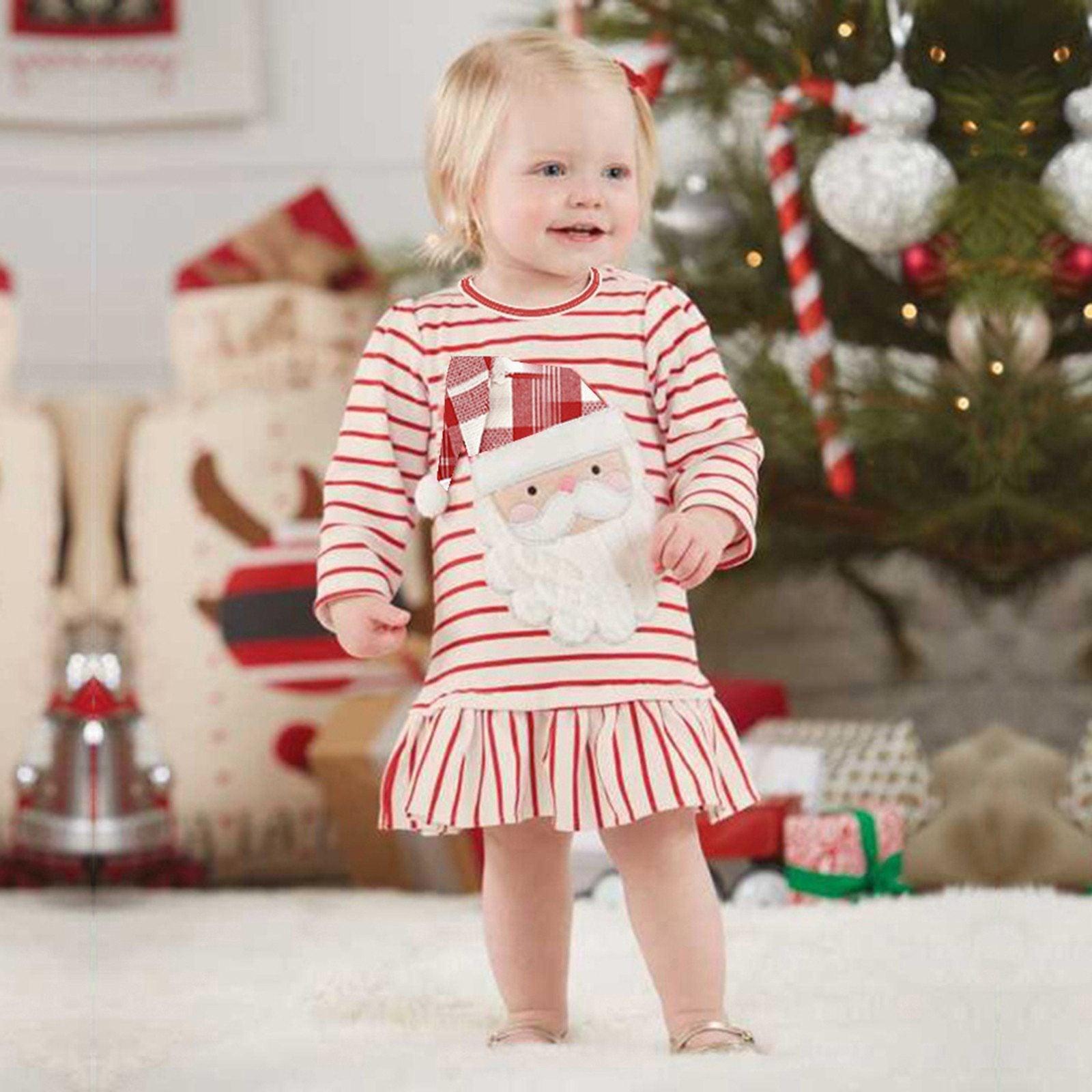 Baby girl wearing a long sleeve striped Christmas dress