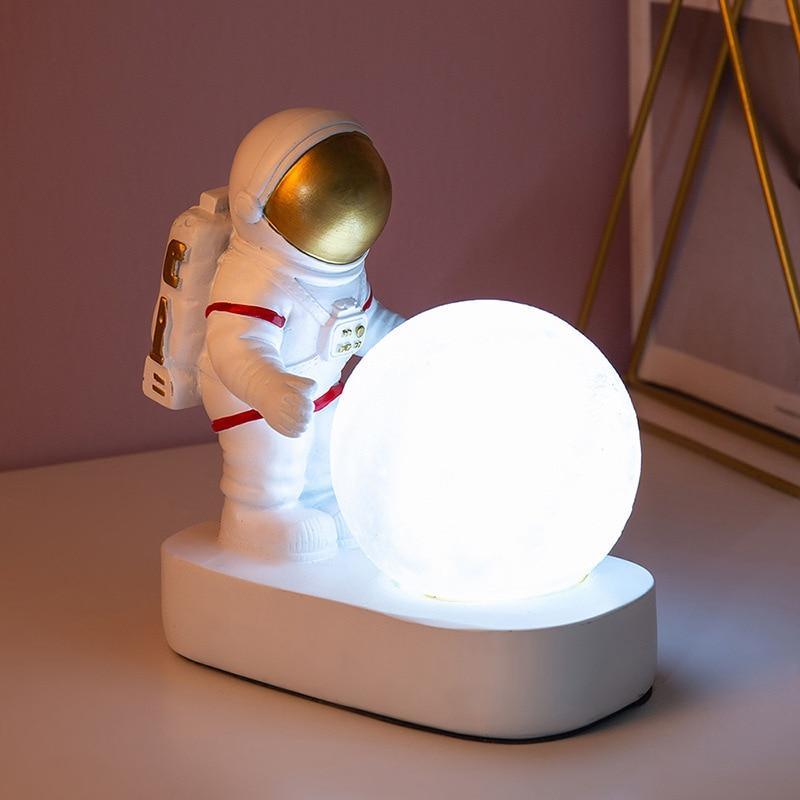 Modern resin astronaut night light available in gold and white.
