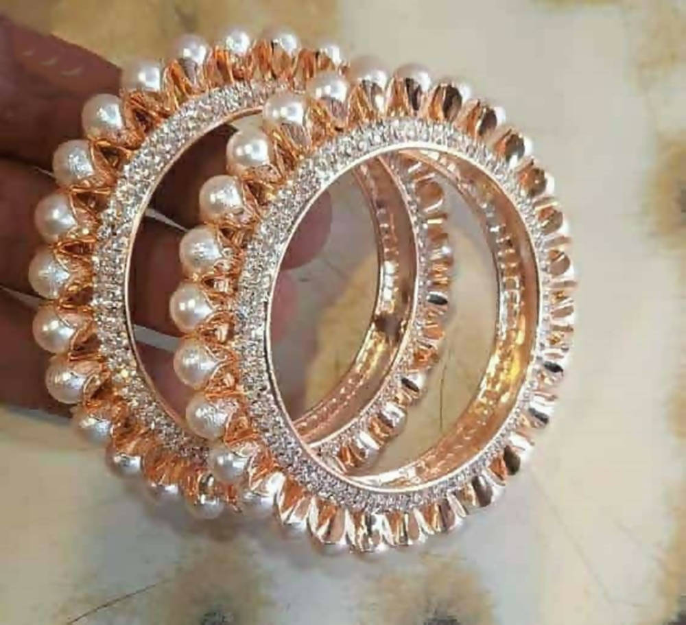 Gold-polished bangles featuring American diamonds and pearls for women