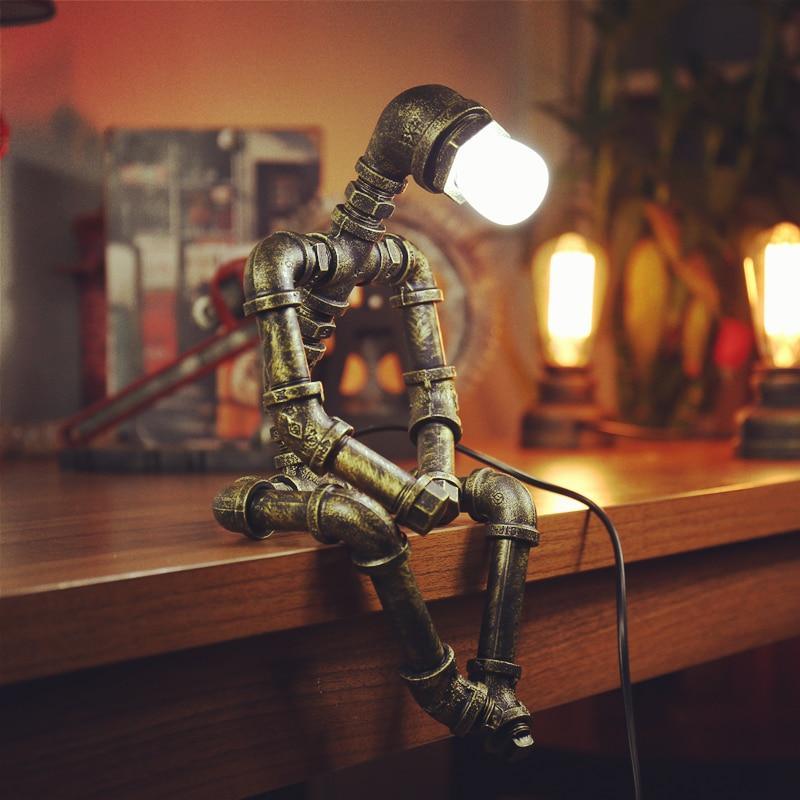 Vintage industrial table lamp made of iron pipes on a desk.