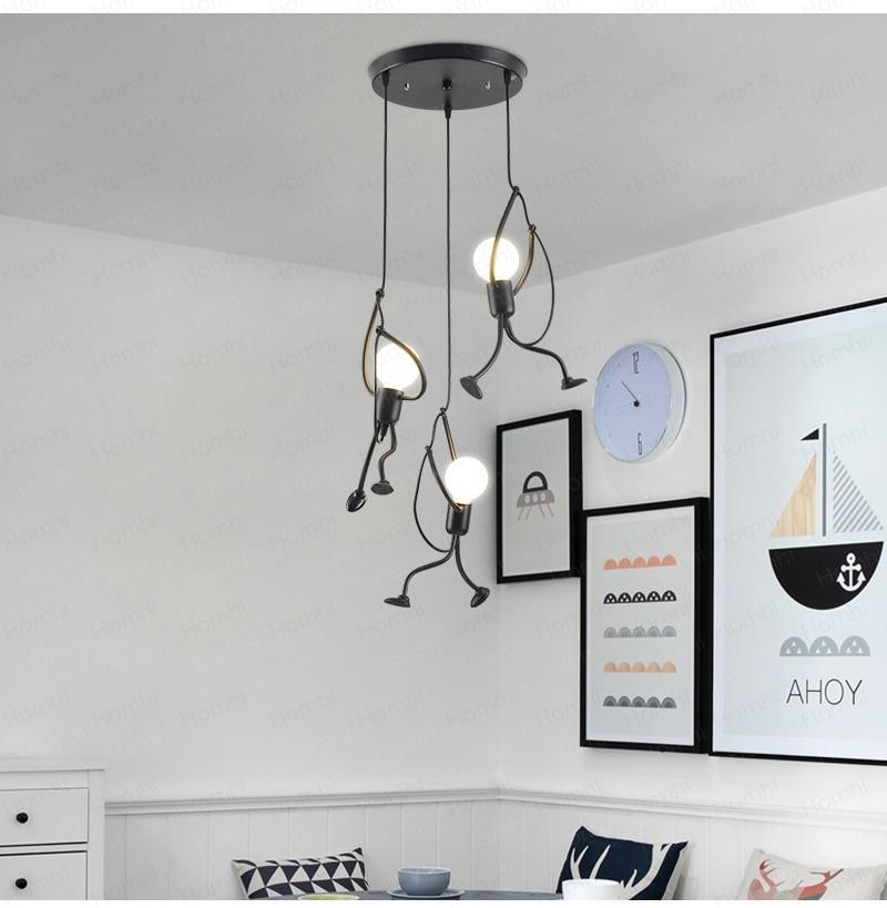 Creative black pendant light featuring a figure climbing, hanging in a modern bedroom.
