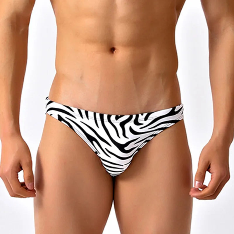 Close up front view of a man wearing a zebra print low-cut swim brief.