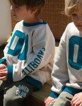 Child wearing an oversized inspirational crewneck sweatshirt for everyday comfort and style.