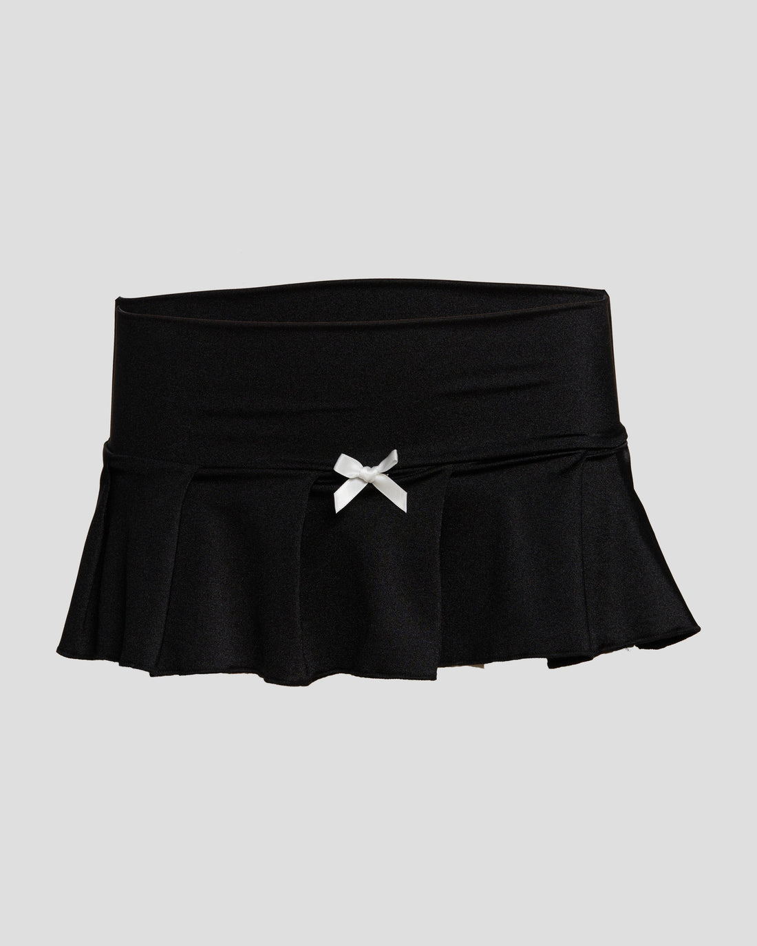 Black and white Kitty Girl micro mini skirt with pleated design, satin bow, and back rhinestone details.