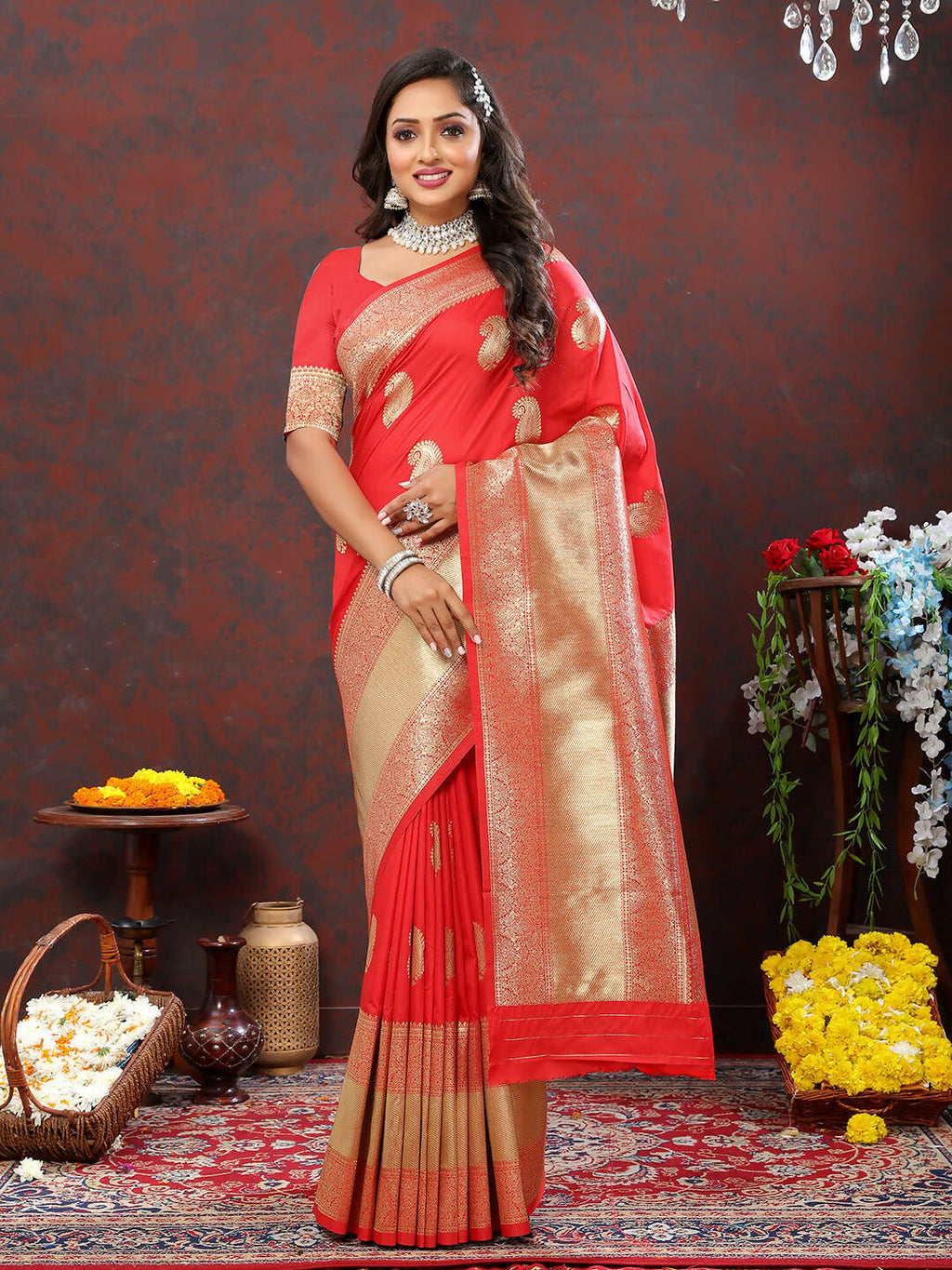 Red soft silk saree featuring traditional gold zari woven detailing