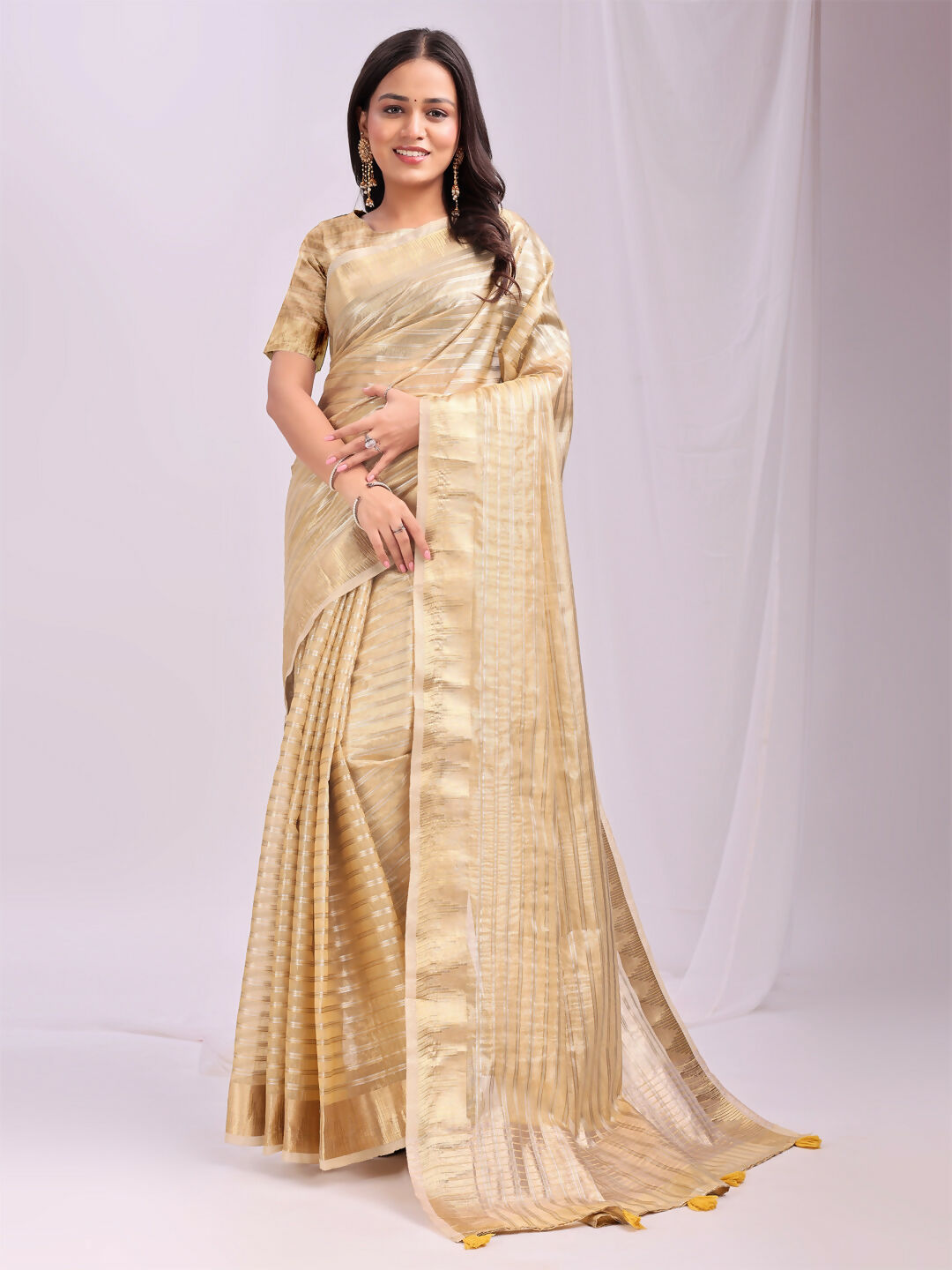 Close up of gold organza fabric saree with yellow blouse material