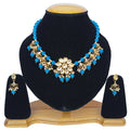 A handcrafted Firozi Kundan necklace set with gold plating and adjustable cord.
