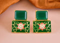 Close-up of elegant green onyx earrings in polished brass for women