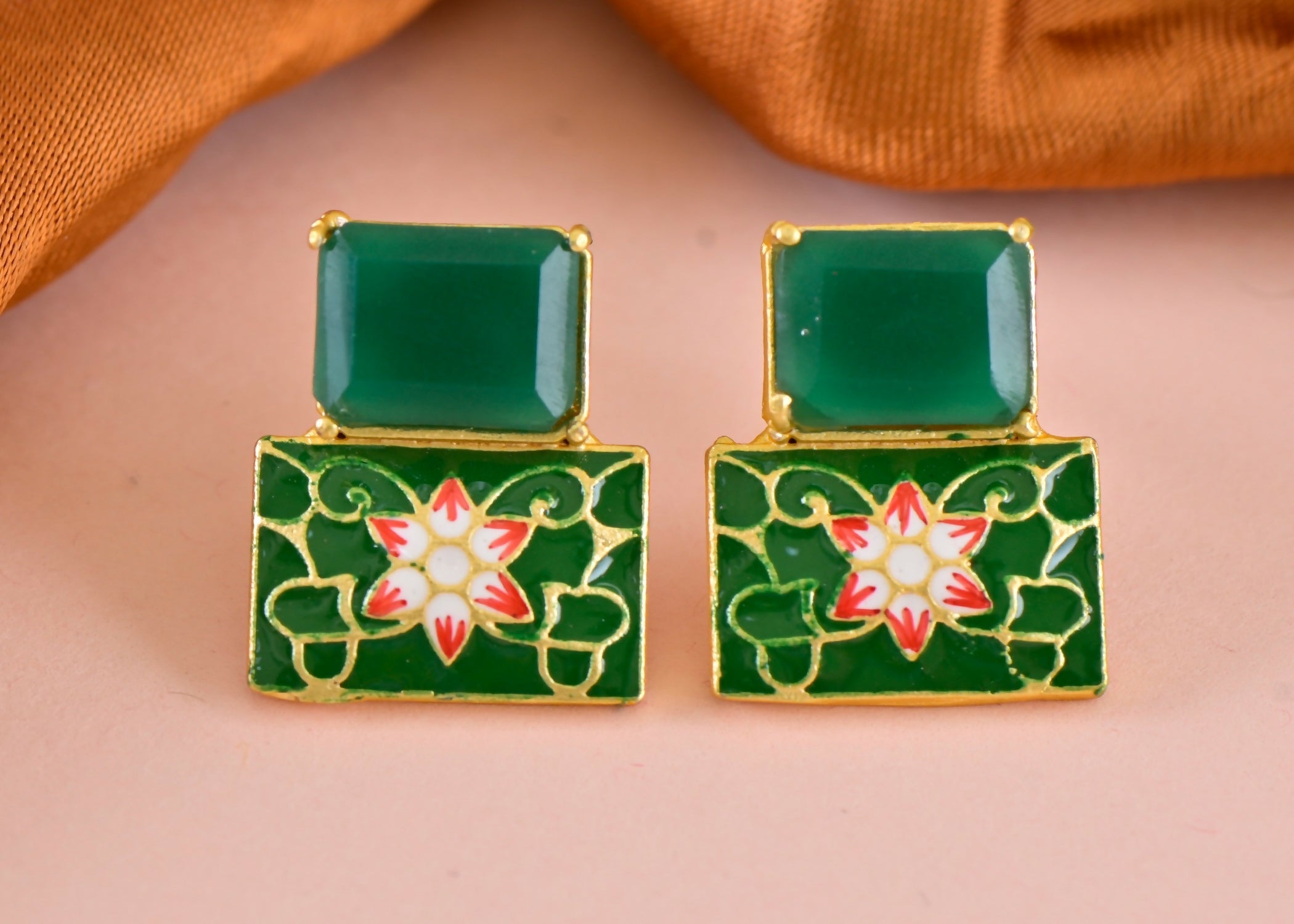 Close-up of elegant green onyx earrings in polished brass for women