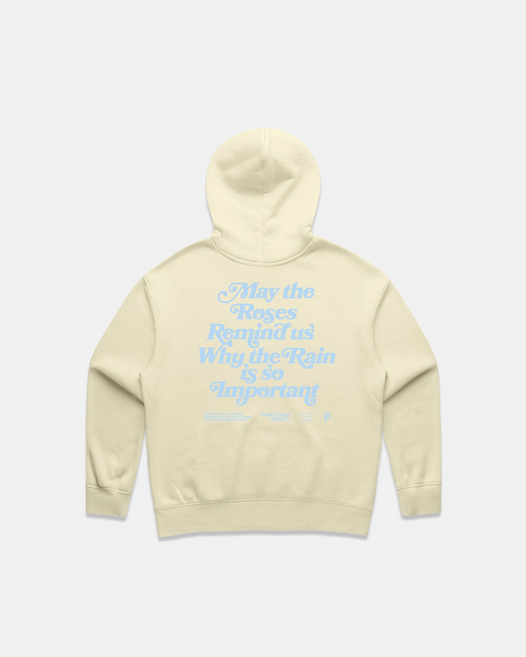 Back view of a Butter colored hoodie with a light blue puff screen print slogan about roses and rain.