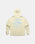 Back view of a Butter colored hoodie with a light blue puff screen print slogan about roses and rain.