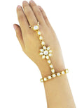 Close up of a Gold Polished Kundan Pearl Chain Hathphool on a hand