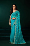Turquoise blue net party wear saree with a contrasting black velvet blouse