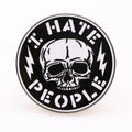 Close up of the I Hate People Enamel Pin on a dark background, ideal for bags or apparel.