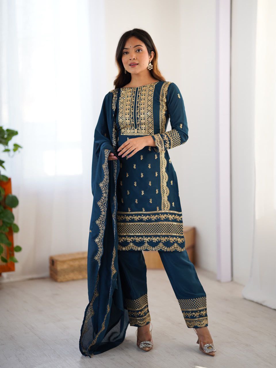 A front view of a blue Chinon silk salwar suit with intricate sequins embroidery and a tailored fit.